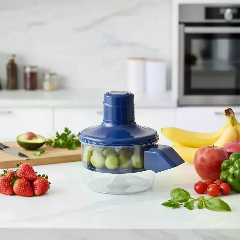Blue electric grape peeling machine with grapes inside and assorted fruits beside it
